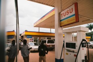 “Reflections on Gas Passed” • Kodak Ektar 100 • Canon Rebel K2 35mm • Sigma 24-70mm f2.8 ••••#uganda #gas #film #reflection #bus #overcast #africa #men #standing